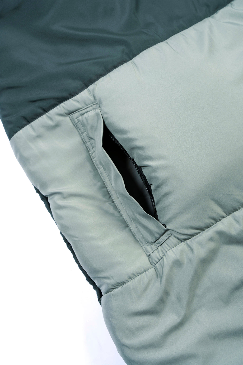 Close-up of a green wearable SnoozePod's arm opening with zipper